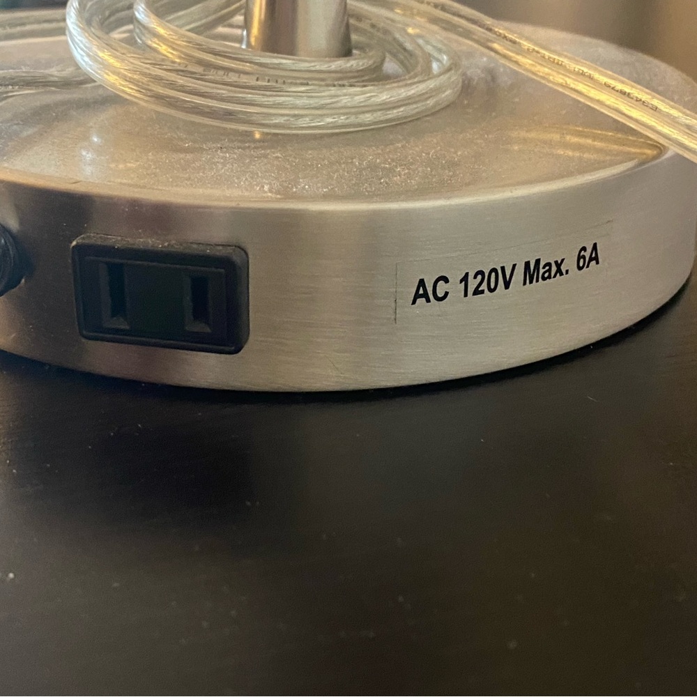 Silver desk lamp with outlet connected